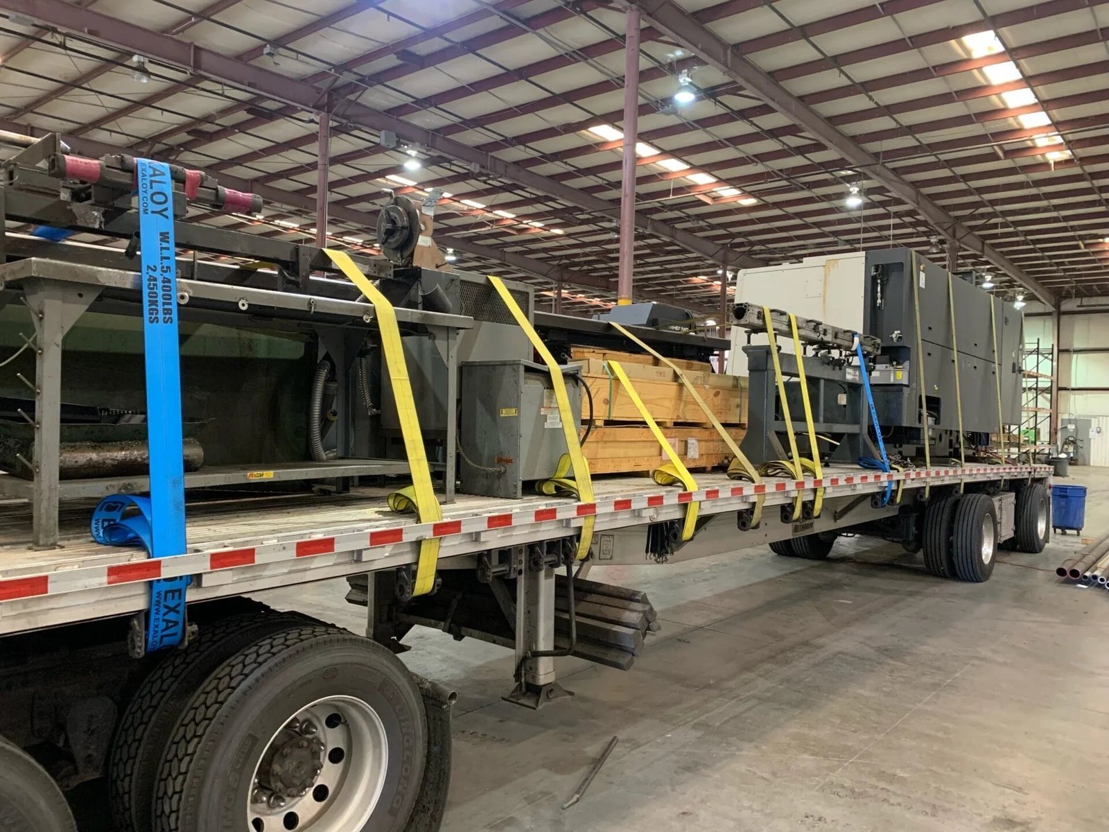 Machinery secured flatbed riggers transport international relocation AZVIR